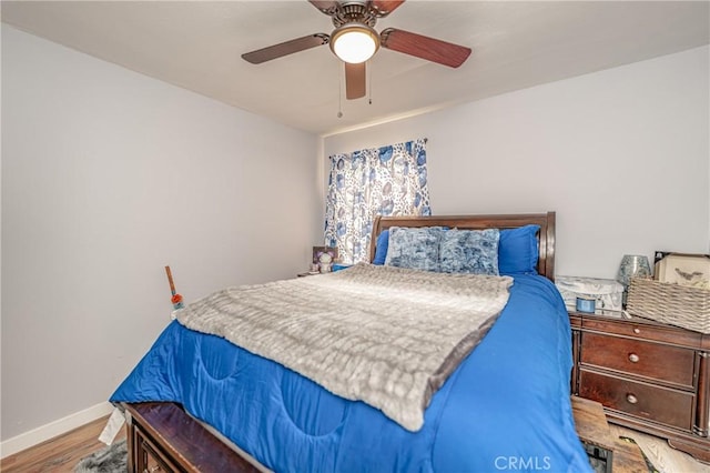 bedroom with hardwood / wood-style floors and ceiling fan