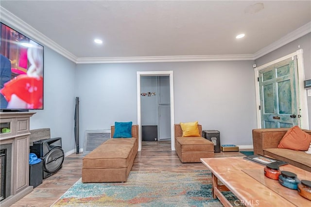 living room with hardwood / wood-style flooring and ornamental molding