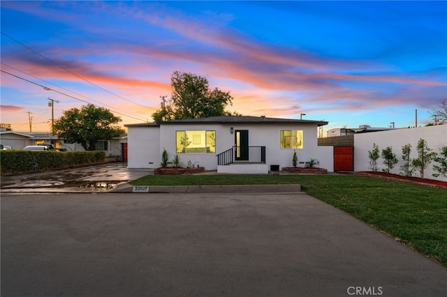 ranch-style home with a yard