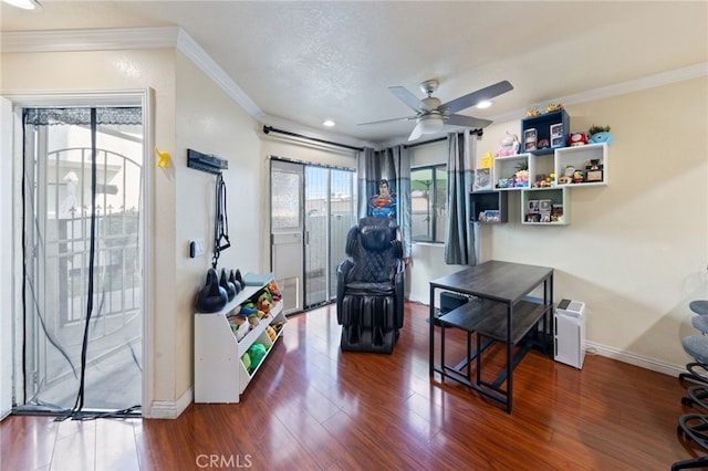 living area with a textured ceiling, ceiling fan, dark hardwood / wood-style flooring, and crown molding