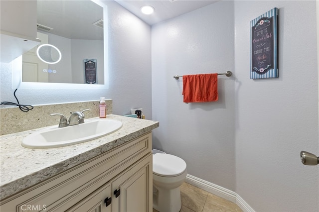 bathroom featuring toilet, tile patterned floors, and vanity