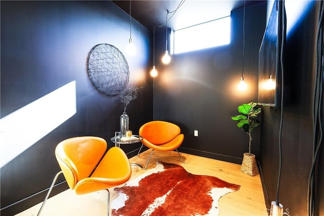 sitting room with hardwood / wood-style flooring