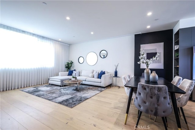 living room with built in features and light hardwood / wood-style flooring