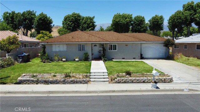 ranch-style home with a front yard and a garage