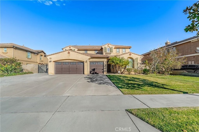 mediterranean / spanish house with a front lawn and a garage