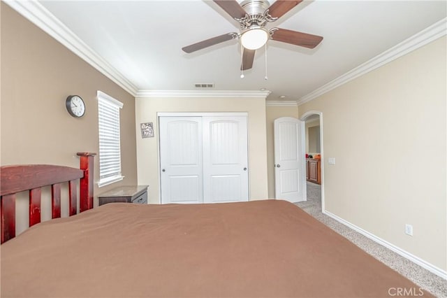 unfurnished bedroom featuring a closet, ceiling fan, ornamental molding, and light colored carpet