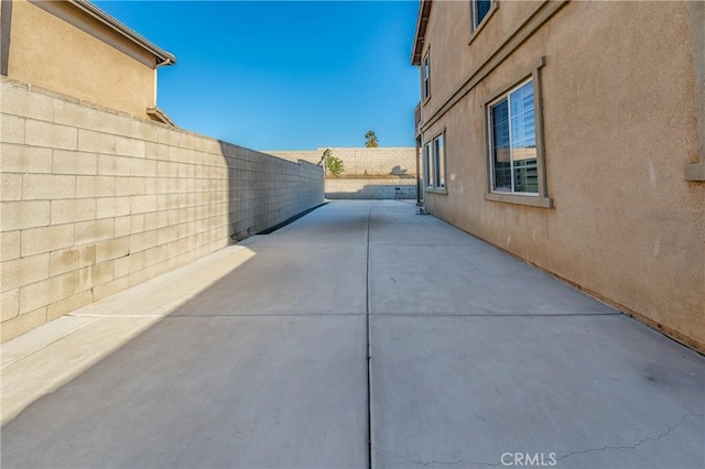 view of property exterior with a patio area