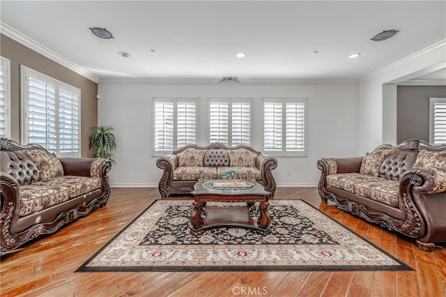 living room with ornamental molding and light wood-type flooring