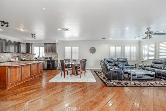 living room featuring light wood-type flooring, ceiling fan, and ornamental molding