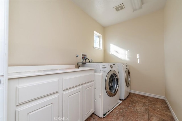 washroom featuring cabinets and washing machine and dryer