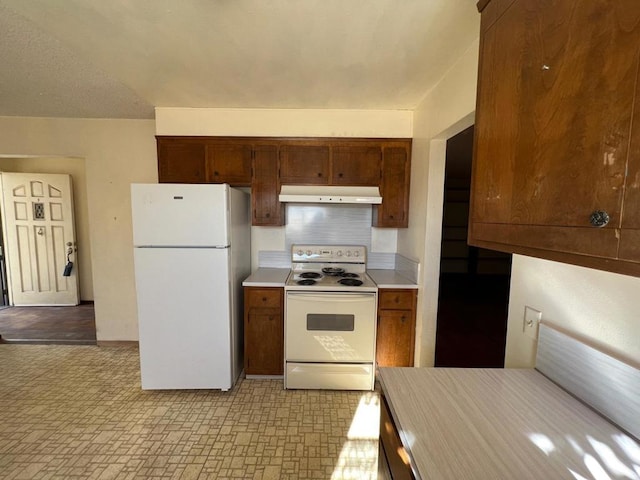 kitchen featuring tasteful backsplash and white appliances