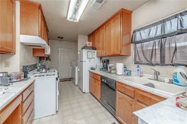 kitchen with sink, white appliances, and a textured ceiling