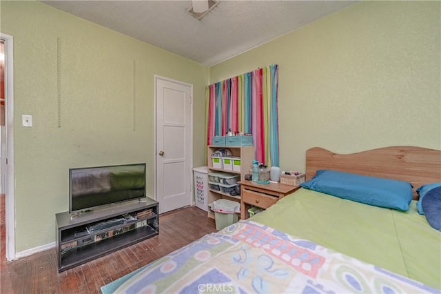 bedroom with hardwood / wood-style flooring