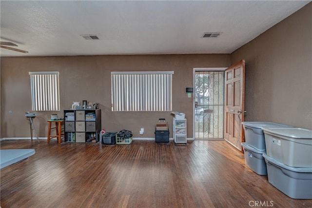 misc room with wood-type flooring and ceiling fan