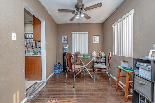 dining space with dark hardwood / wood-style floors and ceiling fan