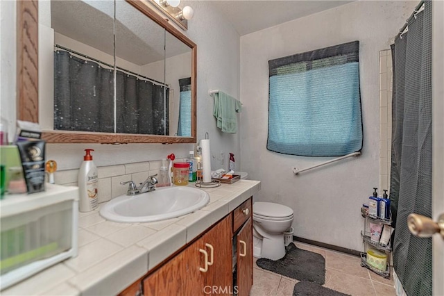 bathroom with vanity, tile patterned floors, and toilet