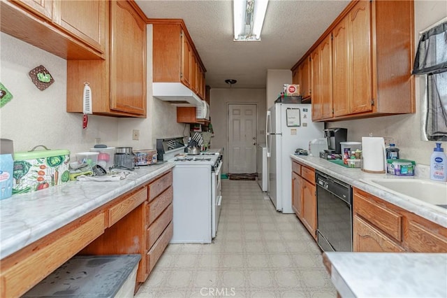 kitchen featuring white appliances and a textured ceiling