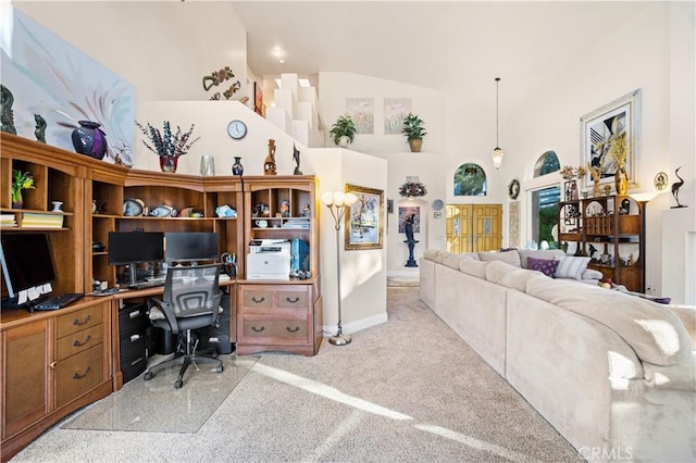 home office featuring high vaulted ceiling and light colored carpet