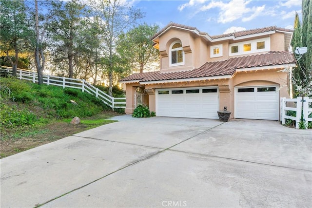 mediterranean / spanish house with a garage