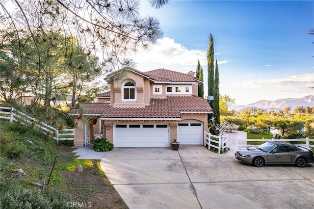 mediterranean / spanish house featuring a mountain view and a garage