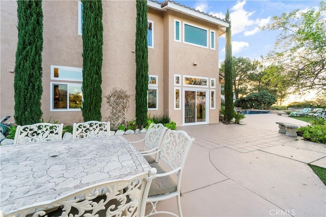 rear view of property featuring a patio