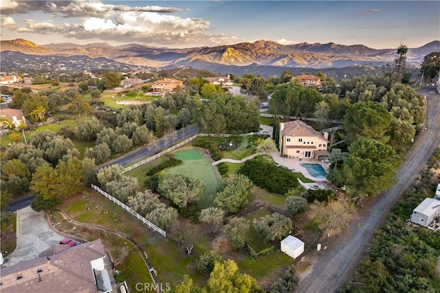 aerial view at dusk featuring a mountain view