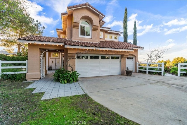 mediterranean / spanish-style house with a garage