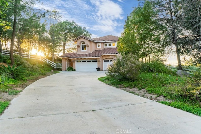 mediterranean / spanish-style house with a garage