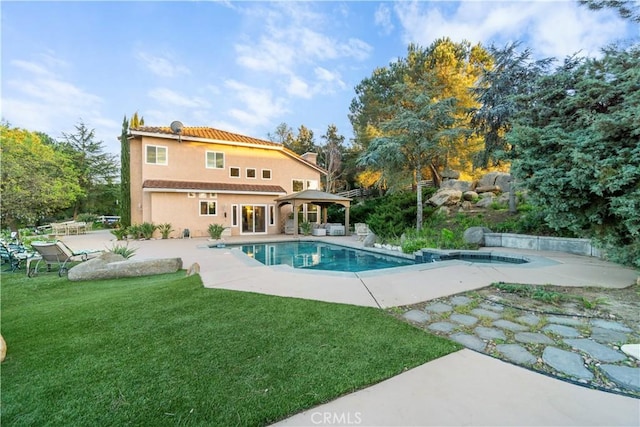 back of house featuring a lawn, a patio, and a gazebo