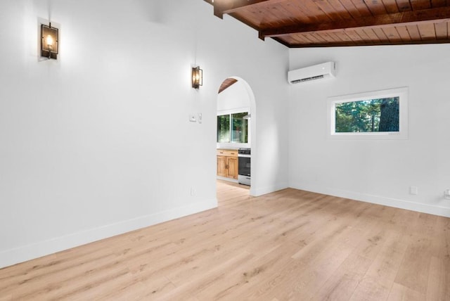 spare room with plenty of natural light, wooden ceiling, lofted ceiling with beams, and an AC wall unit