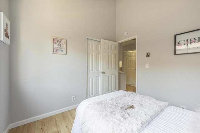 bedroom featuring a closet and light wood-type flooring