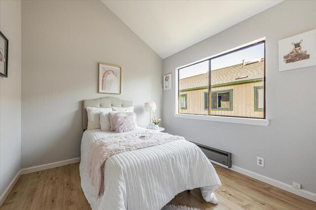 bedroom with light hardwood / wood-style flooring and vaulted ceiling