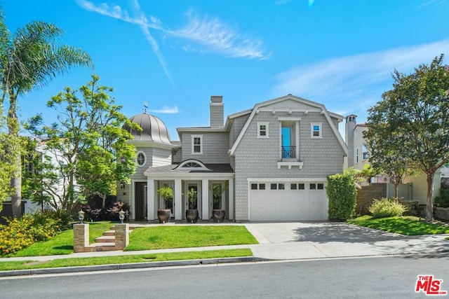 view of front of property with a garage and a front yard