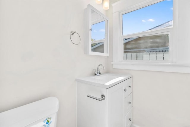 bathroom featuring vanity and toilet