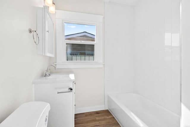 full bathroom with toilet, hardwood / wood-style flooring, shower / bath combination, and sink