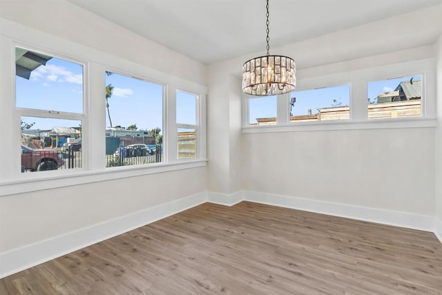 interior space with hardwood / wood-style floors and a notable chandelier