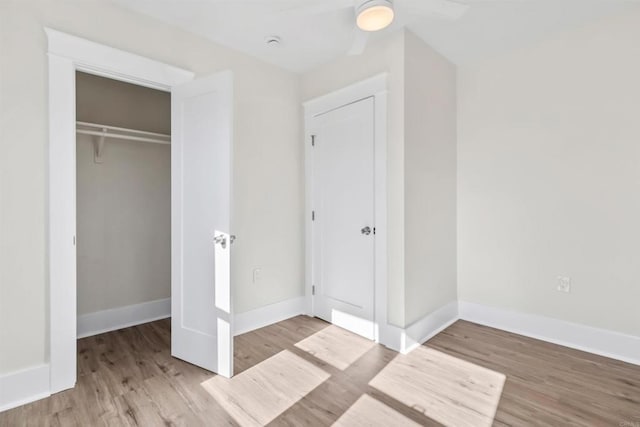 unfurnished bedroom featuring a closet, ceiling fan, and light hardwood / wood-style flooring