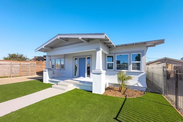 view of front of property with covered porch and a front yard