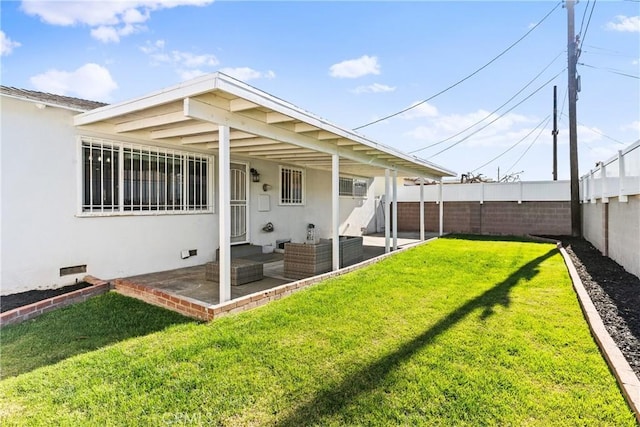 rear view of property with a yard, an outdoor hangout area, and a patio area