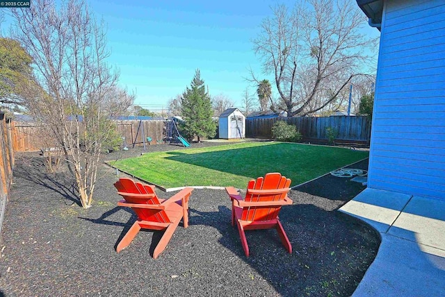 view of yard featuring a playground and a storage shed