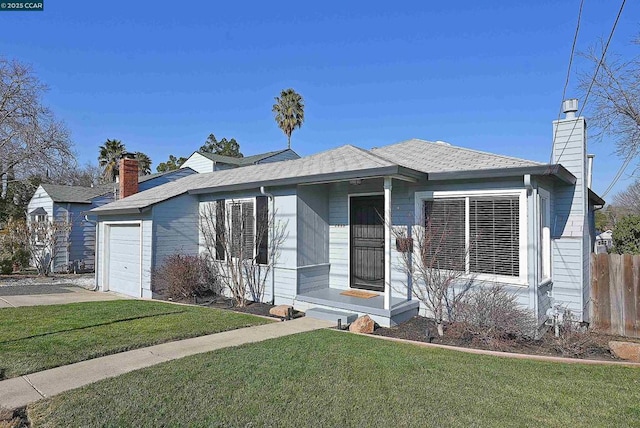 view of front of property with a front yard and a garage