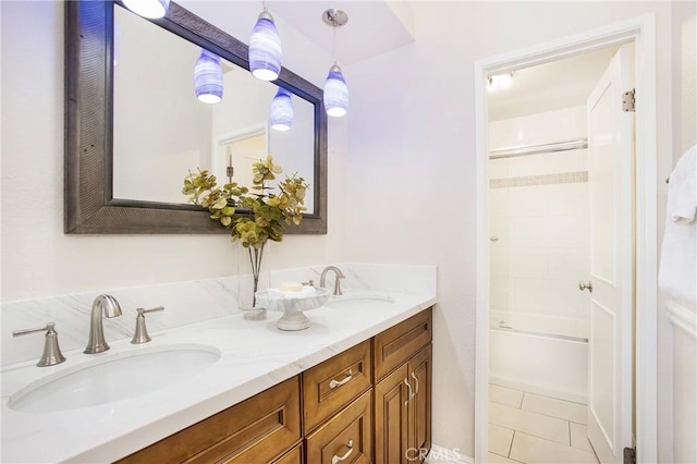 bathroom featuring tile patterned flooring, shower / tub combination, and vanity