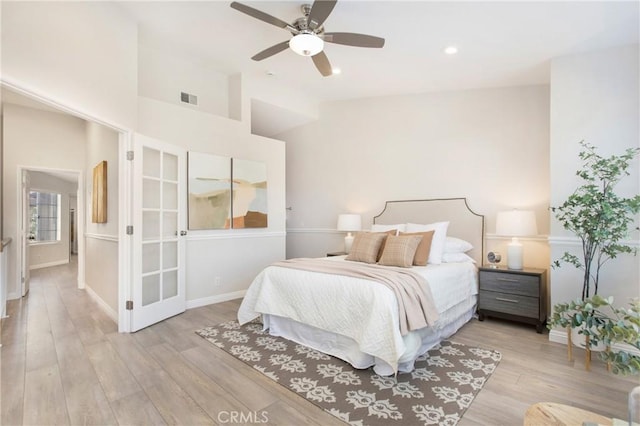 bedroom featuring ceiling fan, vaulted ceiling, and light wood-type flooring