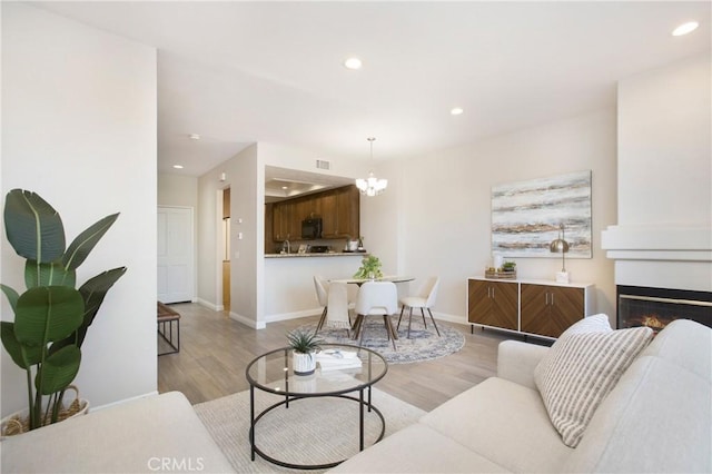 living room with sink and light hardwood / wood-style flooring