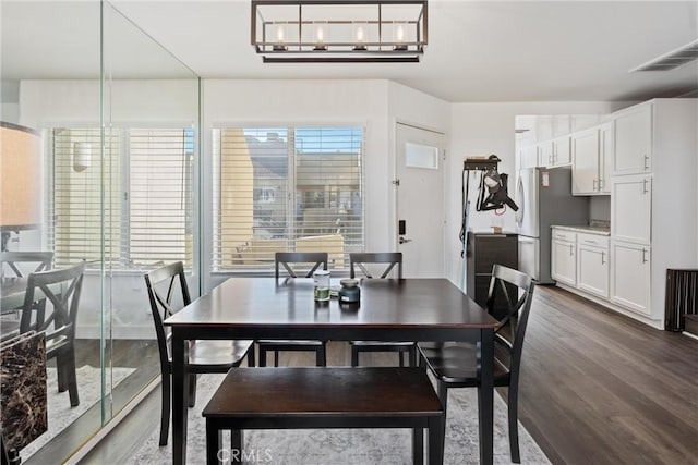 dining area with dark hardwood / wood-style floors