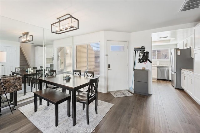 dining space with dark wood-type flooring