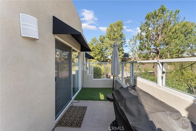 view of patio featuring a balcony