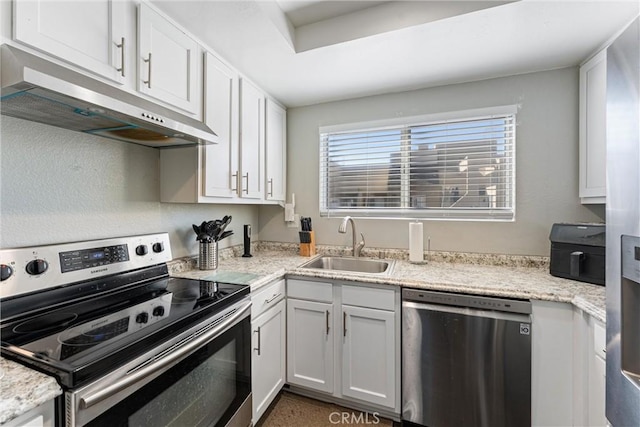 kitchen with stainless steel appliances, white cabinetry, sink, and light stone counters