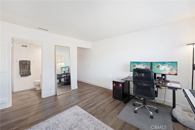 office with dark hardwood / wood-style floors