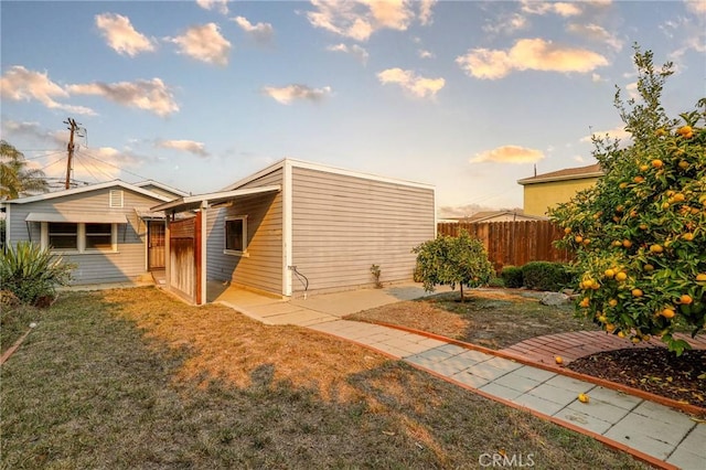 view of side of property with a lawn